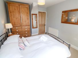 A bedroom with a bed and wardrobe at Pedn Brose Near Mousehole