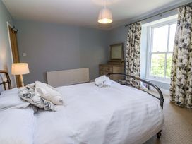 A bedroom with a bed and dressing table at Pedn Brose Near Mousehole