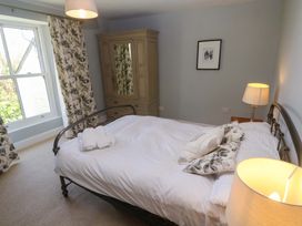 A bedroom with a bed and wardrobe at Pedn Brose Near Mousehole