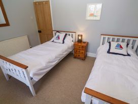 A bedroom with two single beds and a bedside table at Pedn Brose Near Mousehole