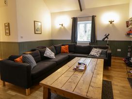 A living room with a sofa and coffee table at The Old Sunday School Cwmwysg near Sennybridge