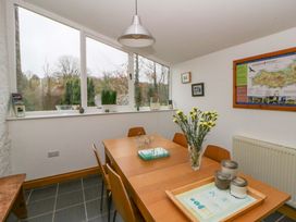 A dining room with a table and chairs at The Old Sunday School in Cwmwysg near Sennybridge