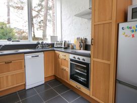 A kitchen with a sink, oven, and dishwasher at The Old Sunday School in Cwmwysg near Sennybridge