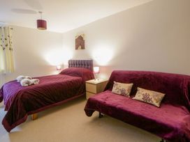 A bedroom with a bed and sofa at The Old Sunday School in Cwmwysg near Sennybridge