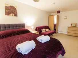 A bedroom with a bed and a mirror at The Old Sunday School Cwmwysg near Sennybridge