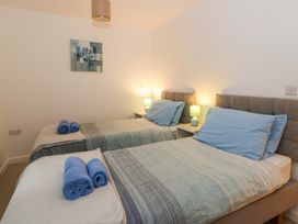 A bedroom with two beds and towels at The Old Sunday School Cwmwysg near Sennybridge
