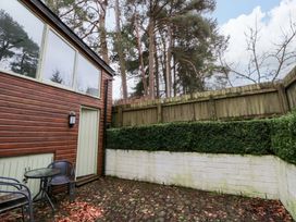 An outdoor area with a wooden wall and seating at The Old Sunday School Cwmwysg near Sennybridge