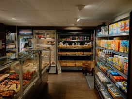 A store interior with shelves of various products and a glass display at Brayton in Aspatria