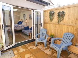 An outdoor seating area with blue chairs and a table at Sea Folly