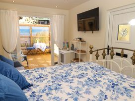 A bedroom with a bed and a television at Sea Folly