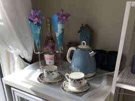 A tea set with cups, a kettle and sparkling wine at Sea Folly in Porthcawl