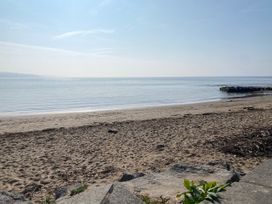 A beach with sand and water at Sea Folly in Porthcawl