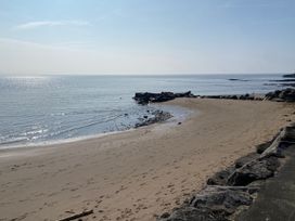 A beach with rocks and sea at Sea Folly in Porthcawl