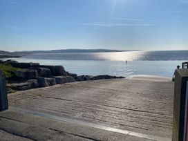 A beach scene with water and rocks at Sea Folly in Porthcawl