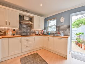 A kitchen with cabinets and appliances at Lisburne Place in Torquay
