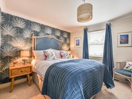 A bedroom featuring a bed and bedside table at Lisburne Place in Torquay