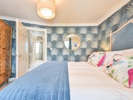 A bedroom with a bed and wardrobe at Lisburne Place in Torquay