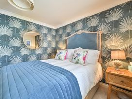 A bedroom with a bed and bedside table at Lisburne Place in Torquay