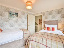 A bedroom with two beds and wall art at Lisburne Place in Torquay