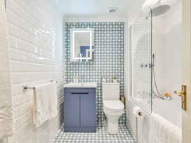 A bathroom with a sink and mirror at Lisburne Place in Torquay