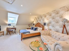 A bedroom with a bed and sofa at Lisburne Place in Torquay