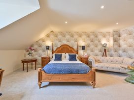 A bedroom with a bed and a sofa at Lisburne Place in Torquay