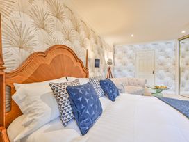 A bedroom with a bed and sofa at Lisburne Place in Torquay