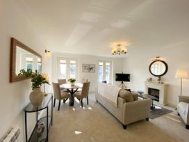A living room with a sofa and a dining table at The Degas Sea View Suite in Torquay