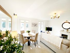 A living room with a table and chairs at The Degas Sea View Suite in Torquay
