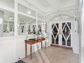 An entrance hall with mirrors and a table at The Degas Sea View Suite in Torquay