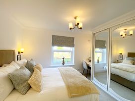 A bedroom with a double bed and a desk in The Degas Sea View Suite Torquay
