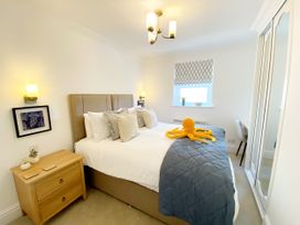 A bedroom with a bed and a nightstand at The Degas Sea View Suite in Torquay