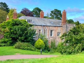 A building surrounded by trees and bushes at The Degas Sea View Suite in Torquay