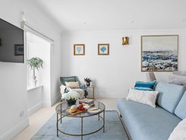 A living room with a sofa and coffee table at The Renior Sea View Suite in Torquay