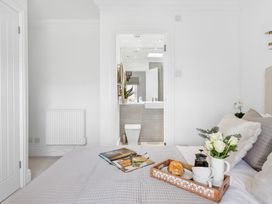 A bedroom containing a bed and a connected bathroom at The Renior Sea View Suite in Torquay