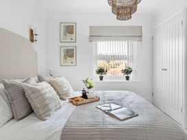 A bedroom with a bed and artwork at The Renior Sea View Suite in Torquay