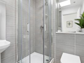 A bathroom featuring a shower and wash basin at The Renior Sea View Suite in Torquay