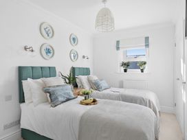 A bedroom with two single beds and decorative plates on the wall at The Renior Sea View Suite in Torquay