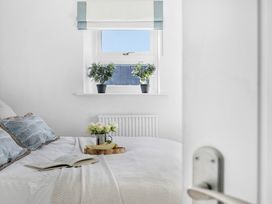 A bedroom with a bed and plants at The Renior Sea View Suite in Torquay