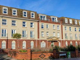 A building with balconies and an entrance sign at The Cobyn in Torquay