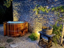 An outdoor area with a hot tub and a wooden barrel at St Anne's Manor Torquay