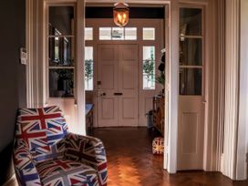 A hallway with an armchair and a door at St Anne's Manor in Torquay