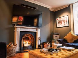 A living room with a television and fireplace at St Anne's Manor in Torquay