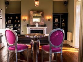 A living room with a table and chairs at St Anne's Manor in Torquay