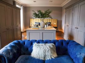 A living room with a blue sofa and a table at St Anne's Manor in Torquay