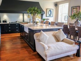 A kitchen with a seating area and artwork at St Anne's Manor in Torquay