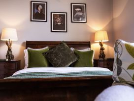 A bedroom with a bed and decorative pillows at St Anne's Manor in Torquay