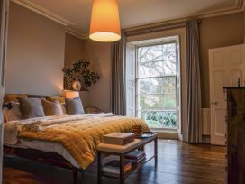 A bedroom with a bed and lamp at St Anne's Manor in Torquay