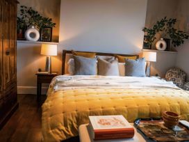 A bedroom with a bed, nightstand, and wardrobe at St Anne's Manor in Torquay