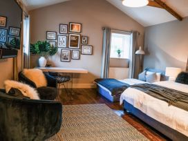 A bedroom with a bed, chair, and desk at St Anne's Manor in Torquay
